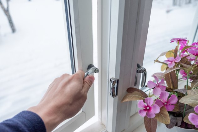 Hand opening window with flower decoration.