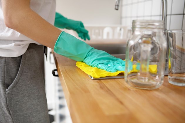 Woman Cleaning Kitchen Counter