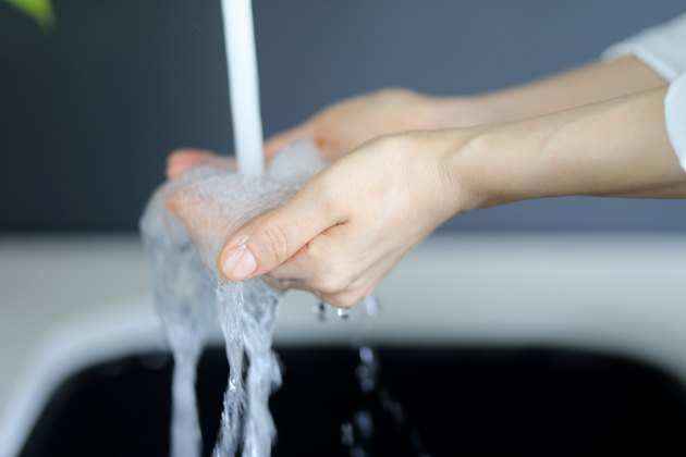 Woman washing hands in washstand