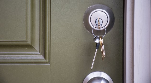 Close up on Keys inside Front Door of New Home ownership at new suburb real estate