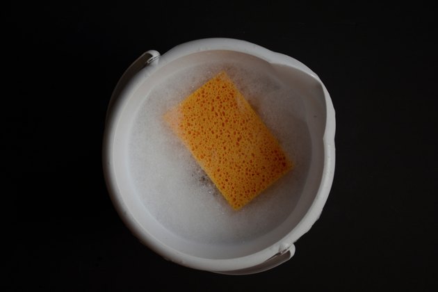 Close-Up Of Bucket With Soap Water And Sponge
