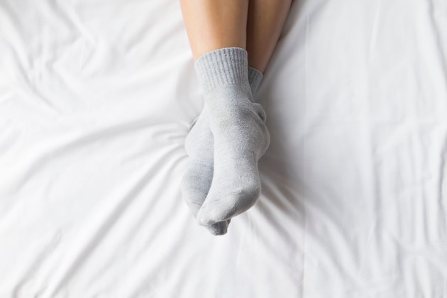 Low Section Of Person On Bed