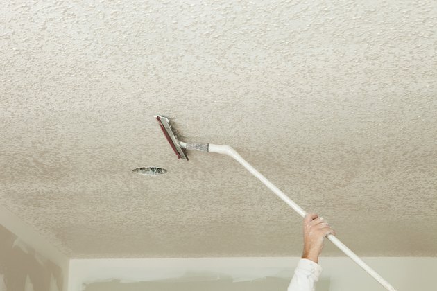 Worker Troweling Drywall Mud on a Ceiling for Knockdown Texture