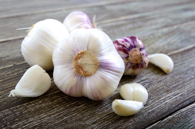 Garlic cloves, garlic bulb on wooden background. Fresh garlic close up. Concept of healthy food.