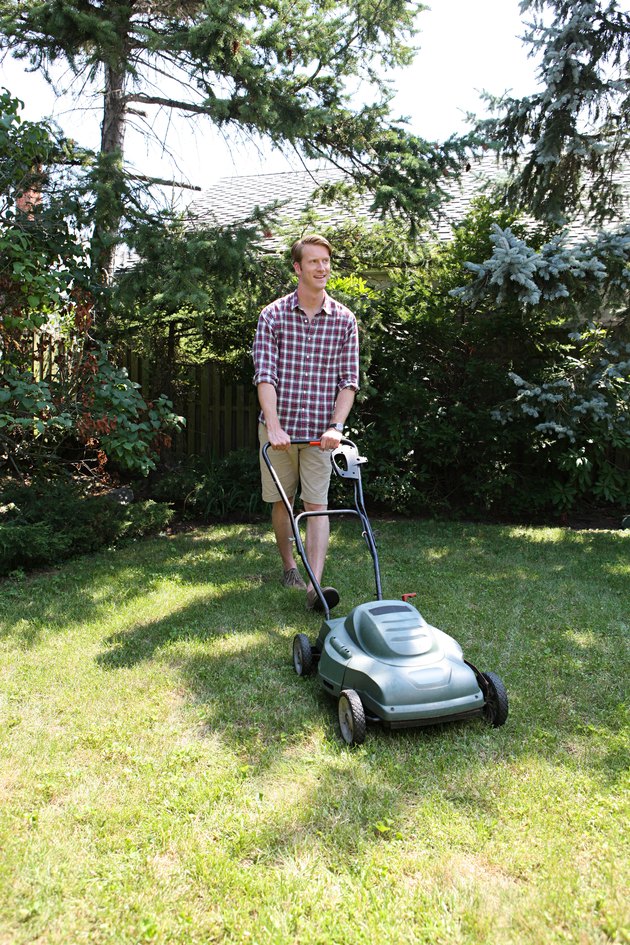 Man mowing grass with lawnmower