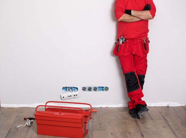 Hands of Plumber with a wrench