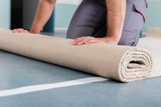 Worker's Hands Rolling Carpet