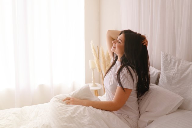Happy woman waking up after good sleeping