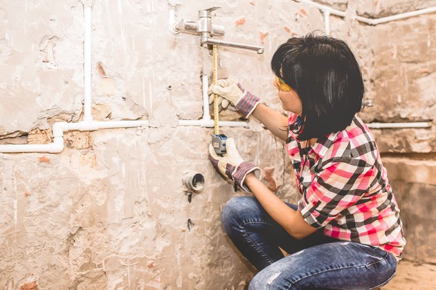 Woman using tape measure.