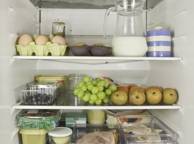 Three fridge shelves full of food