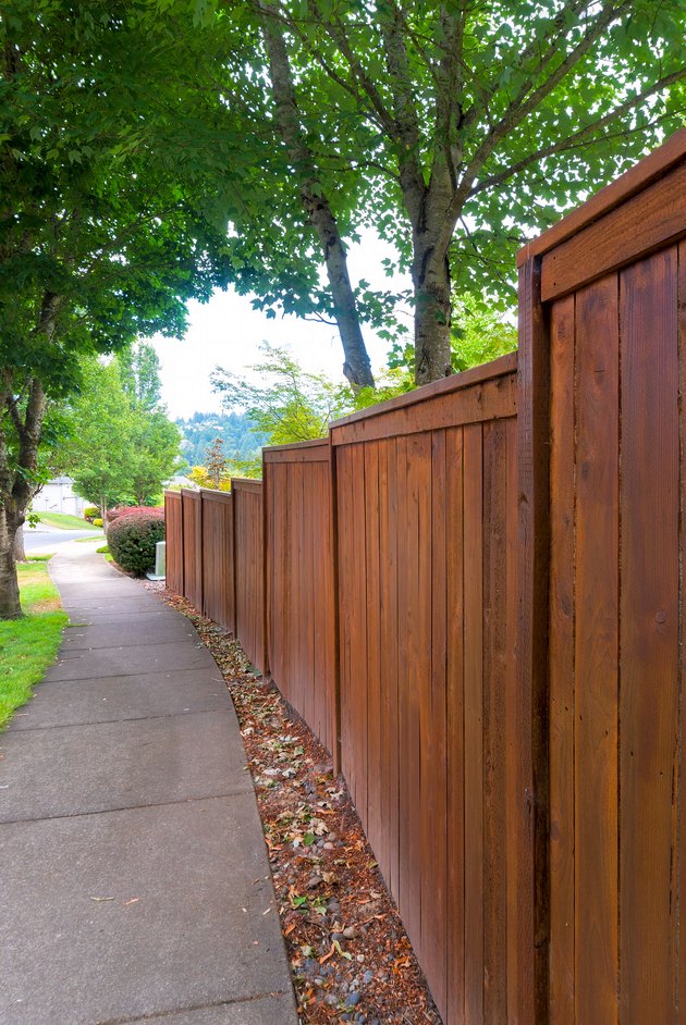 Wooden Fence along suburban neighborhood sidewalk