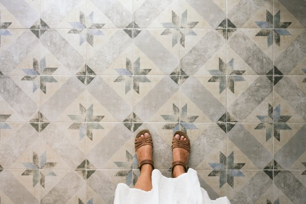 Woman standing on ornate tiled floor