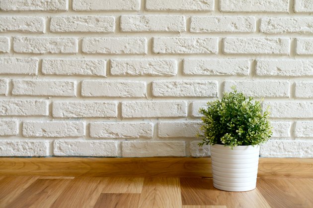empty room with Wood Laminate Floor and Brick wall