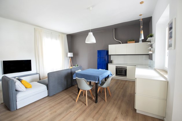 Modern apartment: open space with living room and white kitchen