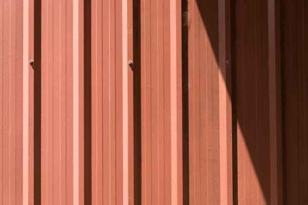 Brown corrugated metal sheet with bolts.