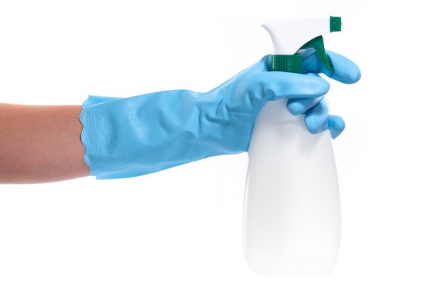 Hand with spray bottle.
