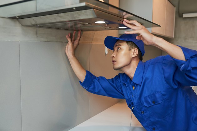 Installing cooker hood.
