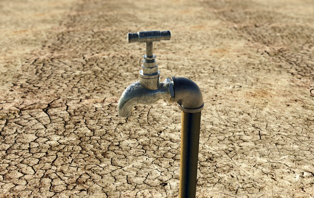 old metal water tap in dry surrounding
