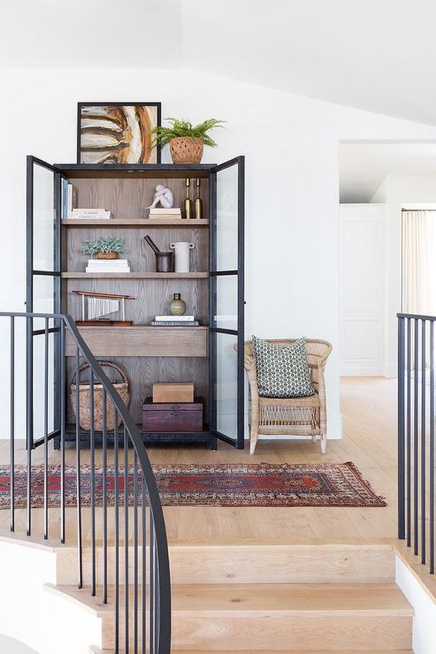 Cabinet with glass doors as hallway storage, designed by Kate Lester Interiors