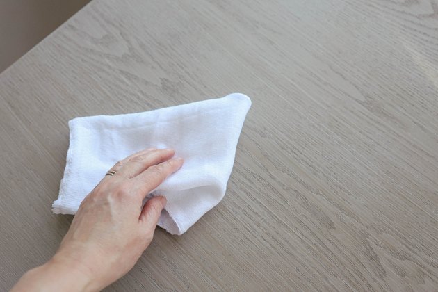 Wiping desk clean with cotton cloth