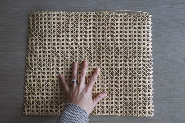 Piece of cane webbing cut to size of tray