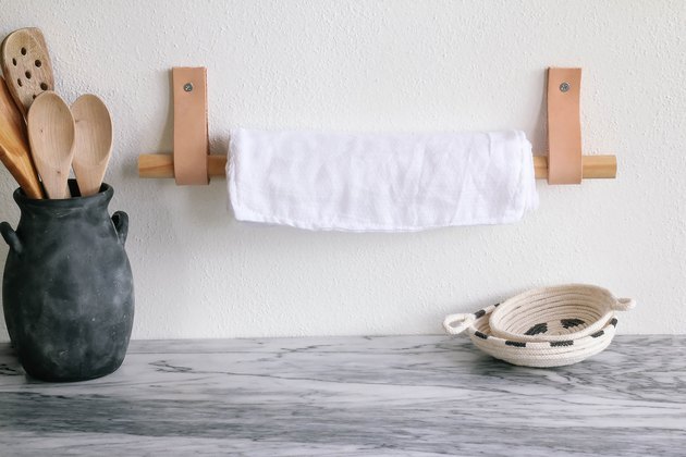 DIY unpaper towels hanging on wood and leather paper towel holder