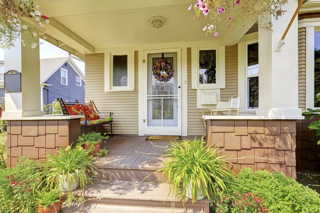 Cozy covered porch with white columns in American craftsman house