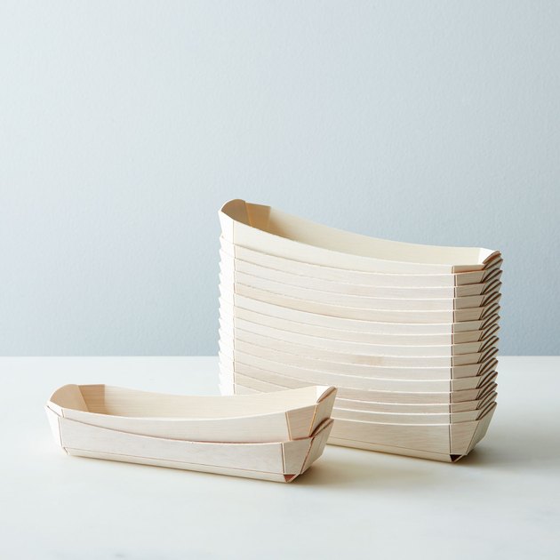 These compostable wooden trays are made from a balsa wood and wrapped in a rice paper finish. Strong and durable with fixed sides and clean lines; the minimalist styling matches any party spread, and they're sized just for hot dogs and sausages. We also like using them for small finger foods like olives or crackers.