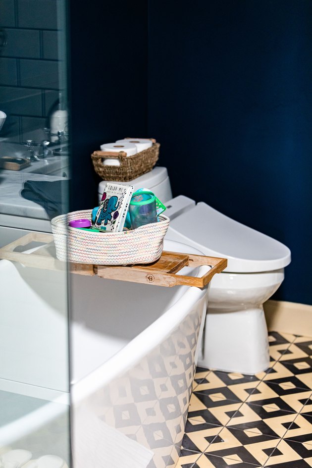White-black geometric bathroom floor with a white bathtub and toilet