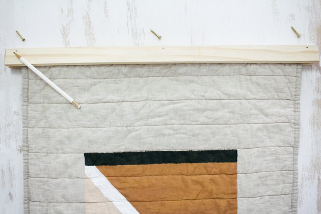 Quilted pillow sham with brown, black and white fabric with pencil
