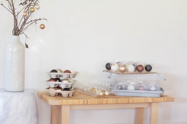 ornament storage with table of containers filled with round ornaments
