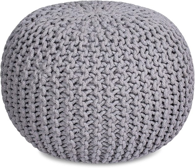 Hand knitted and compact, this ottoman pouf would work well for kids or anyone who loves to lounge.