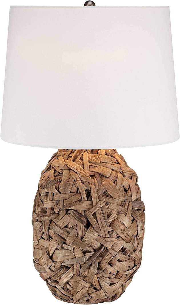 Natural, beach-inspired textures are key in coastal homes — which is why we love this table lamp. It features a base covered in natural seagrass, complemented by a white drum shade.