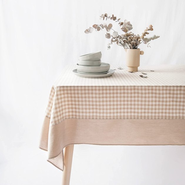 A beige gingham tablecloth that recalls a traditional picnic blanket. Stonewashed cotton gives it an aged look, plus tons of elevated farmhouse style.