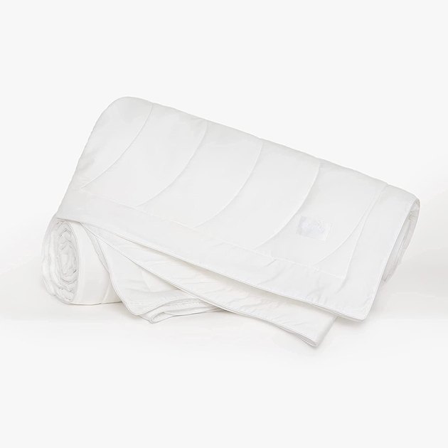 Using a warm comforter when you run hot is a recipe for sleepless nights. That’s where cooling comforters come in, like the Buffy Breeze. Made with 100% eucalyptus lyocell, it’s a lightweight, cool-to-the-touch duvet insert that regulates temperature throughout all the seasons. Keep in mind that the Buffy Breeze can only be dry cleaned and isn’t machine washable, so it might be best to pair this comforter with a duvet cover.
