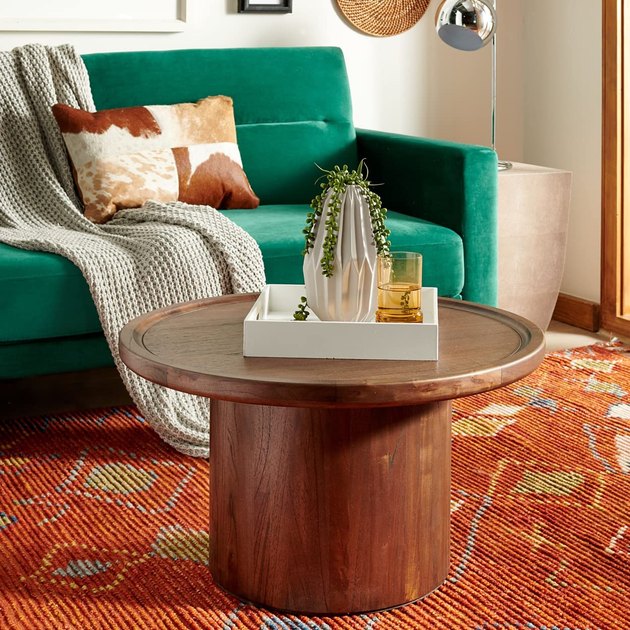 Clean, functional, and beautiful — this round wood coffee table does Scandinavian decor right. Plus, it features a dark oak stain to add instant warmth to any space.
