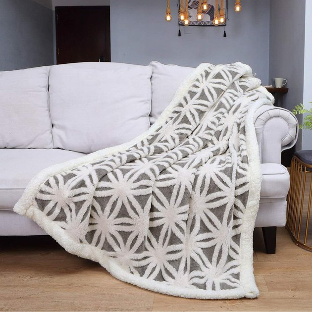 With its fluffy fleece composition, versatile color options, and geometric pattern, this blanket is the ideal cuddle buddy.