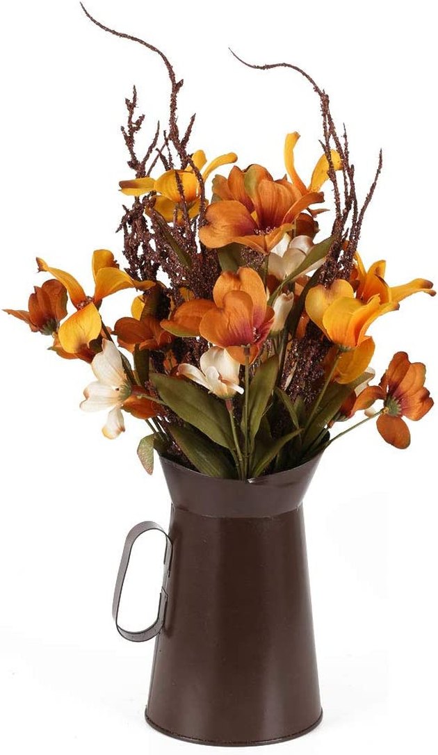 These beautiful silk flowers in a farmhouse-chic metal pitcher add a touch of fall color to a tablescape without being too over-the-top.