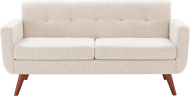 This 65-inch loveseat allows you to furnish a small space without cutting any corners. It features a thick spring foam cushion, clean cream beige upholstery, and splayed midcentury modern-inspired legs.