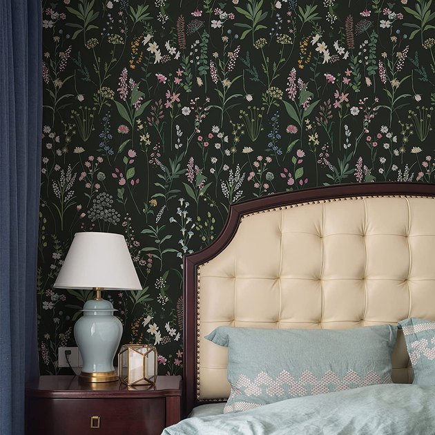 A deep, moody green is the perfect backdrop for stunning florals in this peel-and-stick wallpaper design.