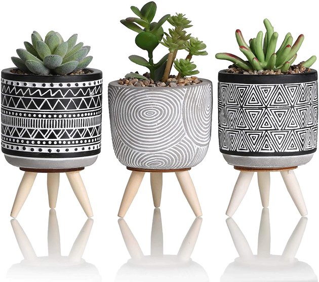 Set of three faux succulents in handmade, midcentury-inspired planters. 