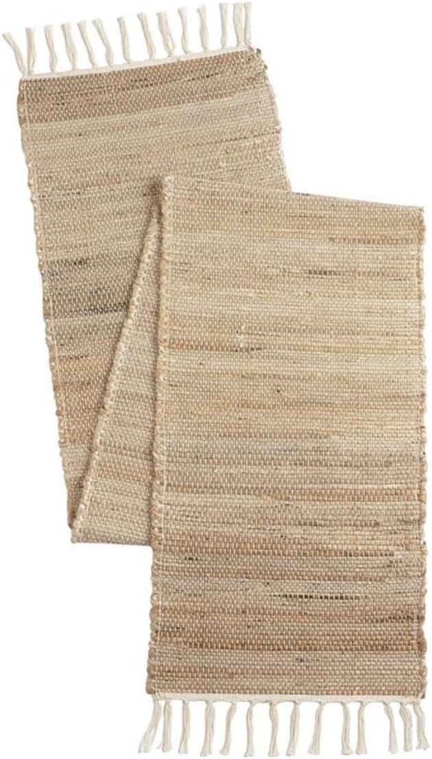 Add boho vibes to your tablescape with this hand-braided jute table runner. It features a decorative tassel design on both ends.