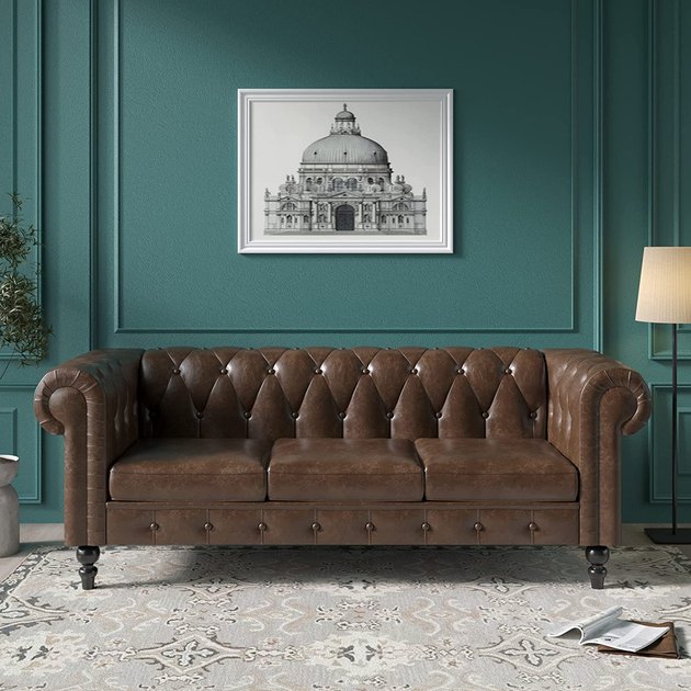 This faux leather chesterfield looks just like the real thing, but for a tiny sliver of the price. If you're working with a small space, it also comes in a loveseat version.