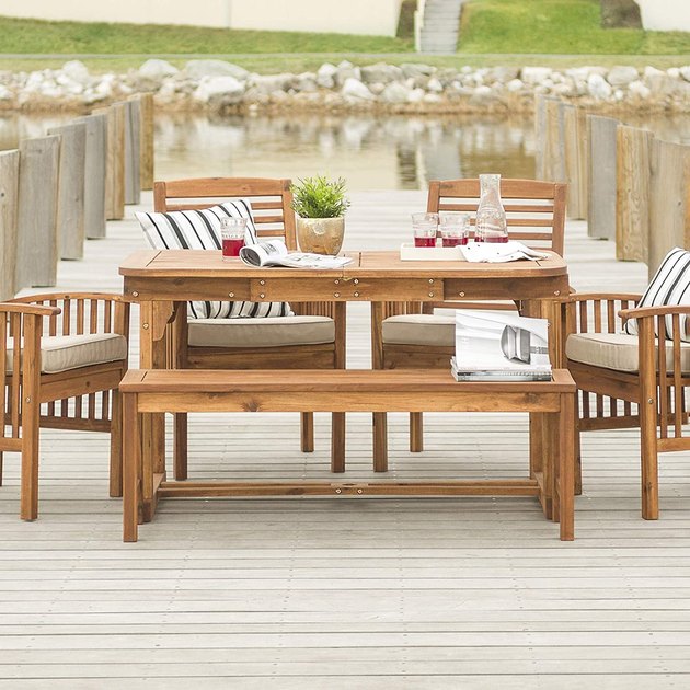 Made from durable wood with a beautiful design, this six-piece patio dining set is made for all your outdoor entertaining needs. It includes four chairs with cushions, a table, and a bench, all made from acacia wood.