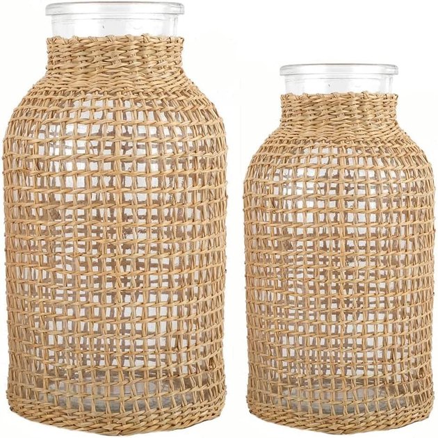 Fill these multipurpose glass vases with fresh flowers, shells, and more. The rattan covers add instant coastal style — and make for the perfect centerpiece.