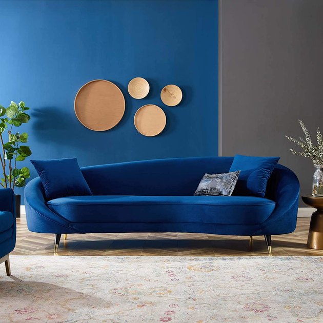 This on-trend option will be the center of attention in your living room. With bold blue velvet upholstery and smooth curves, it's the perfect statement piece.