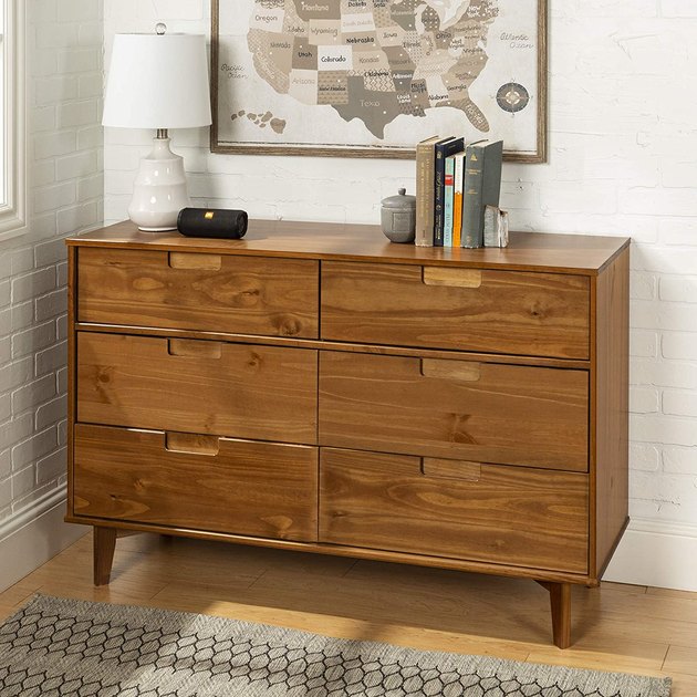 Made of solid pine wood and high-grade MDF, this midcentury-inspired dresser will instantly infuse your bedroom with streamlined style.