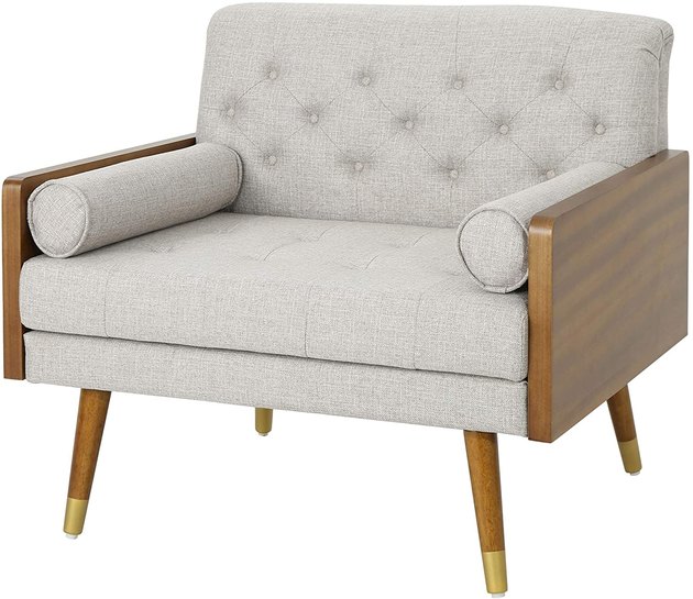 Join the midcentury modern club with this cozy chair. Made with a rubberwood frame and a touch of gold accents, it’s the perfect spot to read a book and relax.