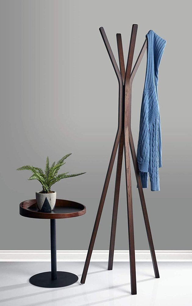 If you want all the benefits of a traditional coat rack without the look, this Amazon find will certainly fit the bill. It holds 50 pounds and is crafted from plywood with walnut oak wood veneer.