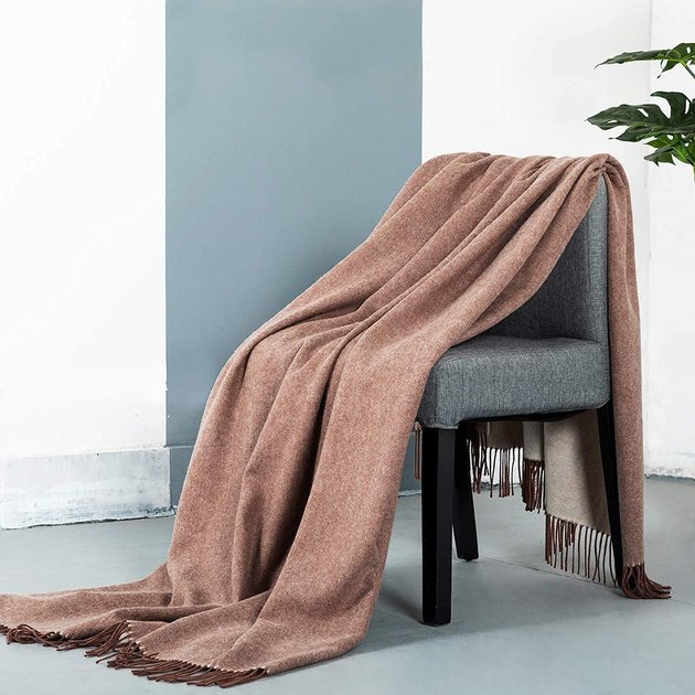 Made from 100% merino wool, this cozy throw blanket will keep you warm all winter long, and look great doing it. 